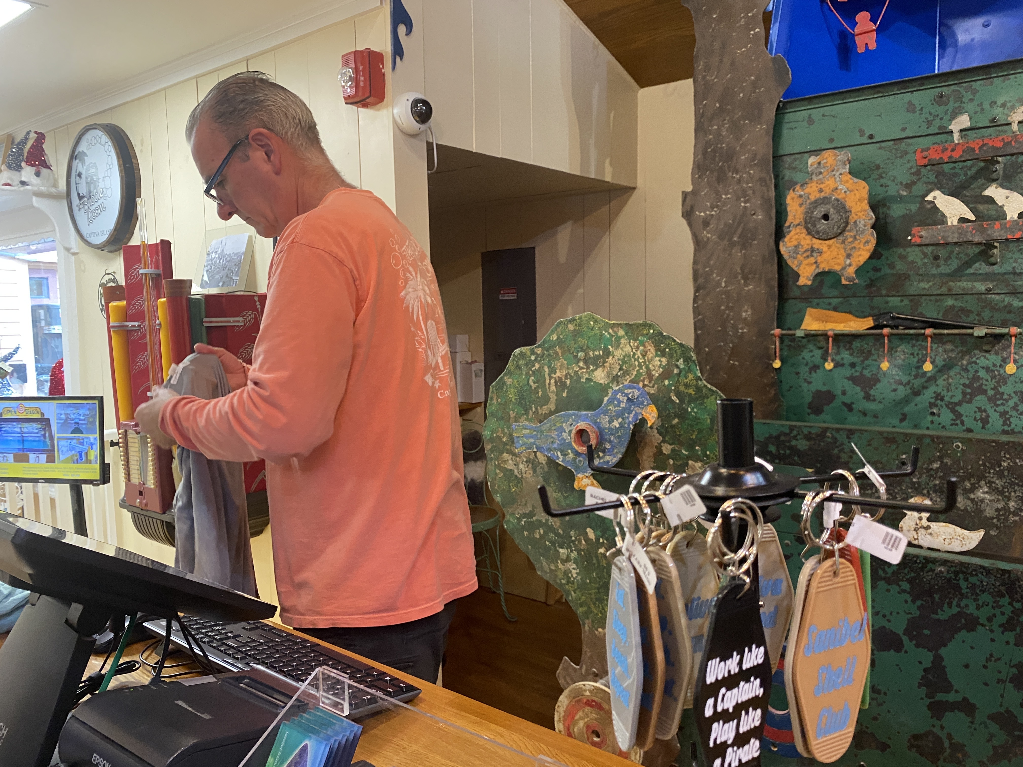 The Emporium clerk rings up two t-shirts.