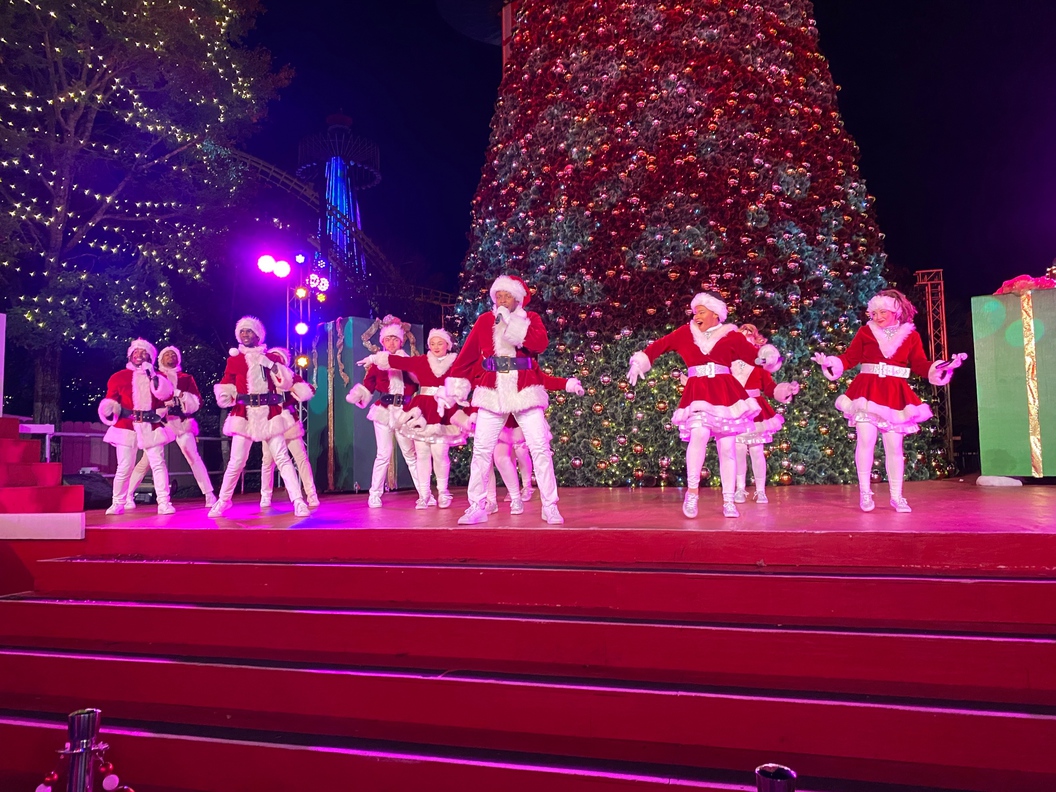 It's time for the Singing Santas at the Celebration Stage at the Plaza.