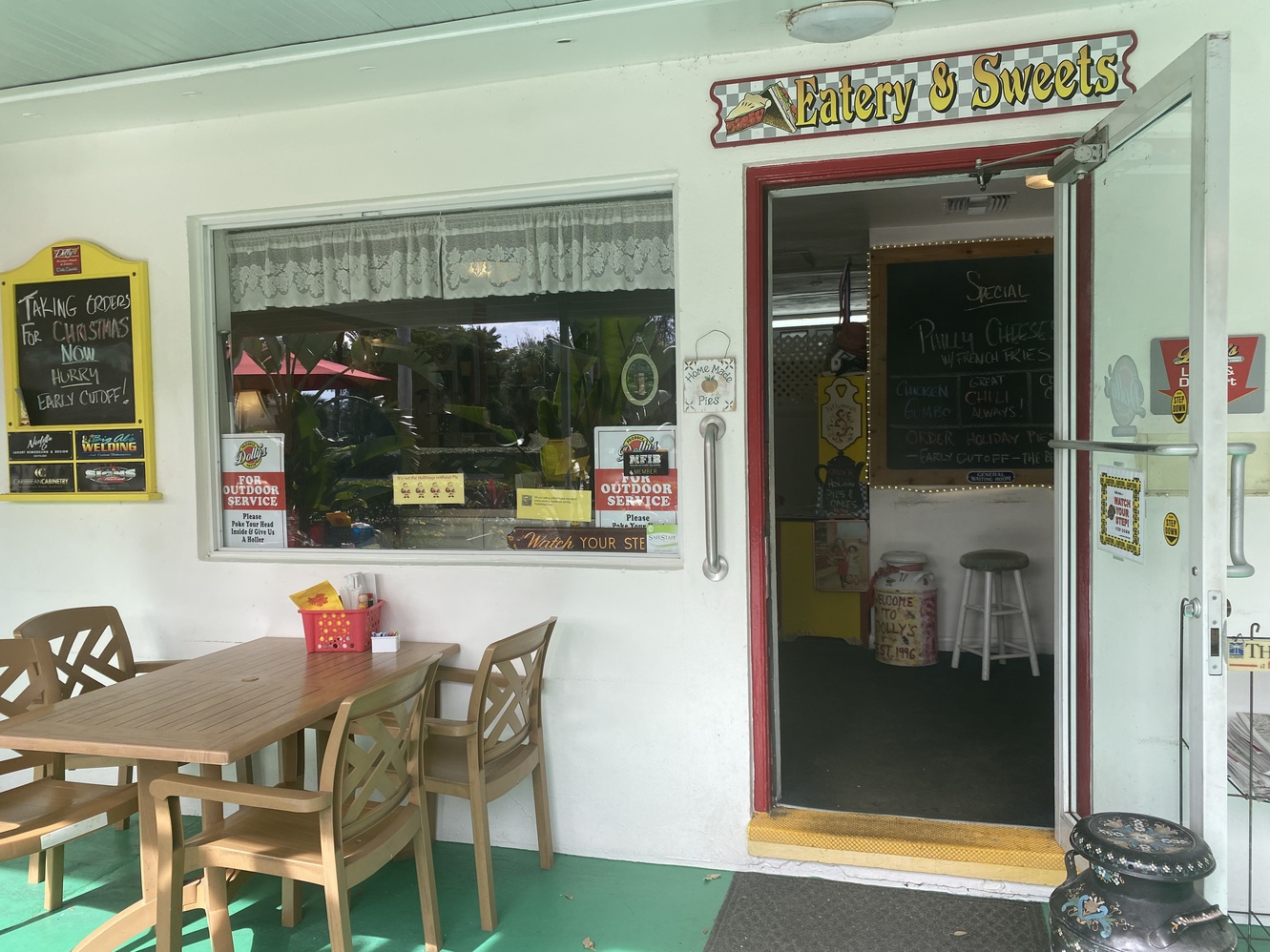 There are tables on the covered patio of Dolly's diner.