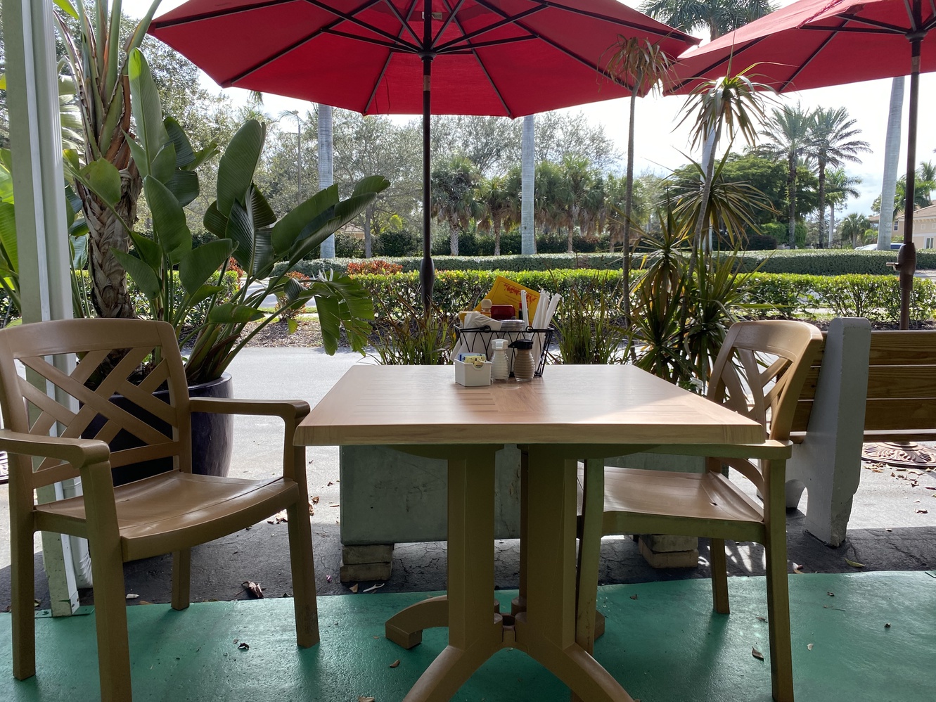 Many of the outdoor tables have umbrellas for shade from the
      sun.