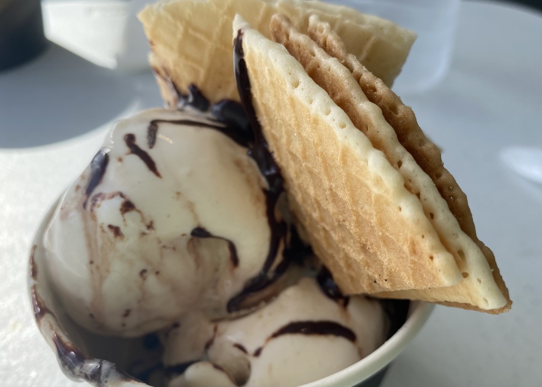 Vanilla ice cream, chocolate sauce, and waffle crisps.