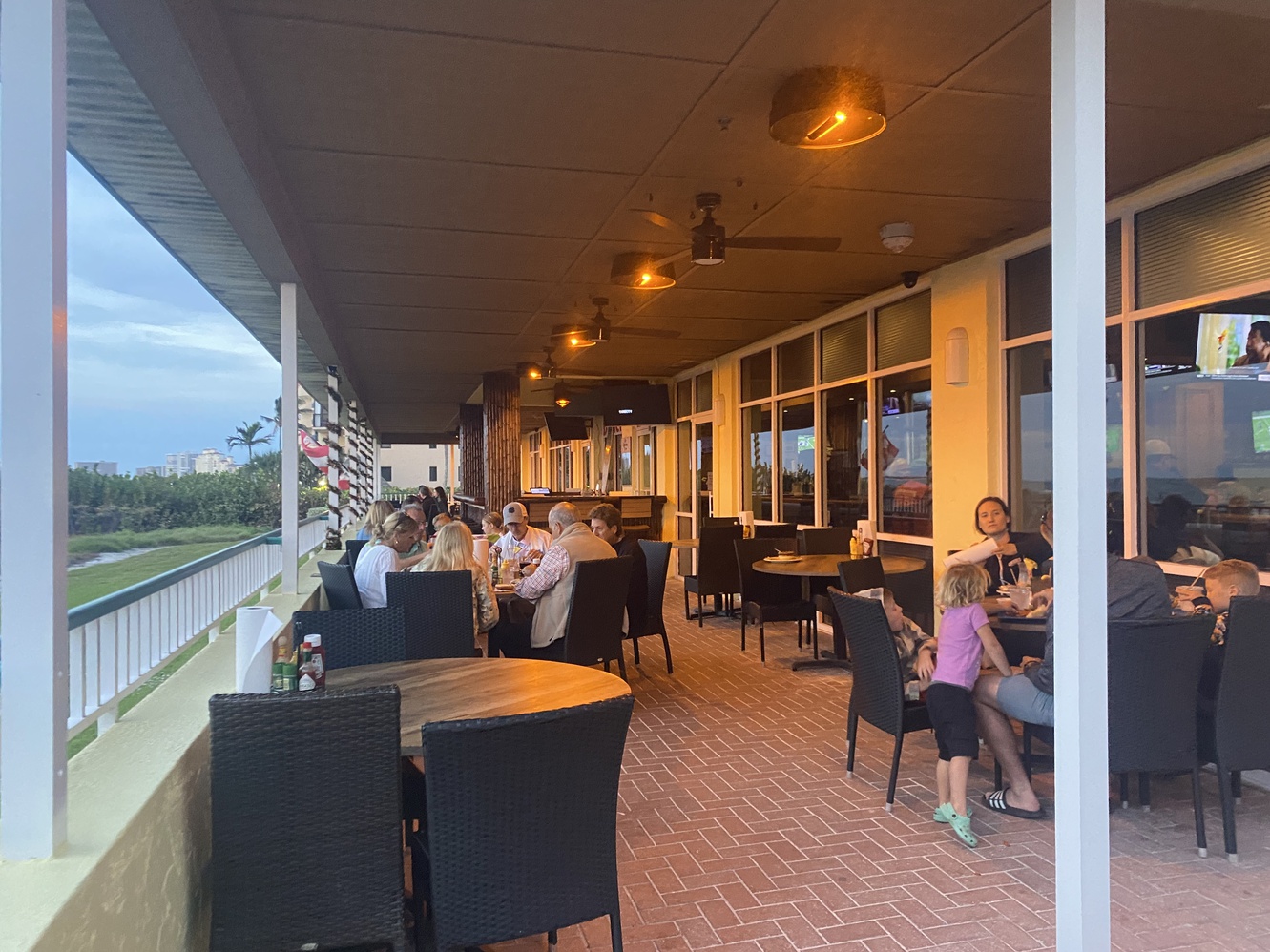 There are as many people on the porch of the Sunset Grille as
      are on the beach.