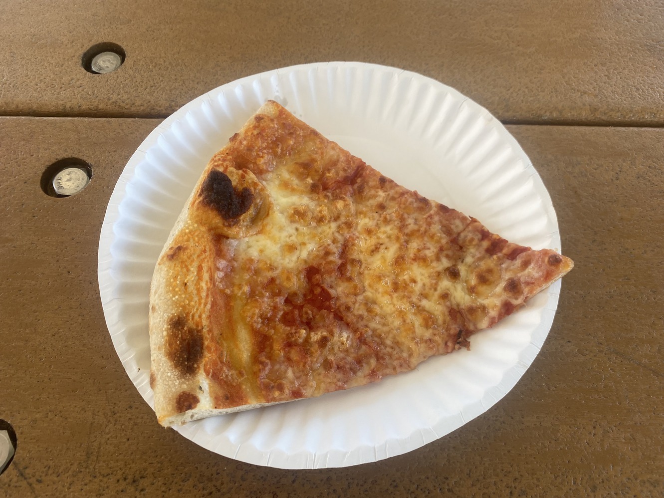 A slice of Cosmos cheese pizza.