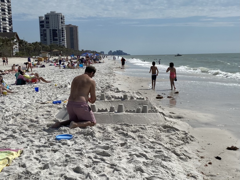 This man and his
      son are building a sand castle on the beach.