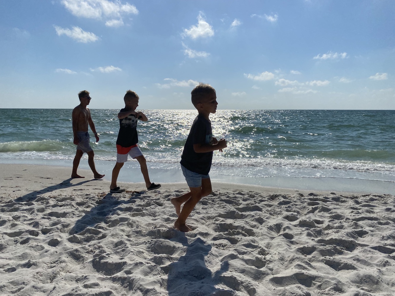 Three guys
      enjoying their time in late afternoon sun at Vandy Beach.