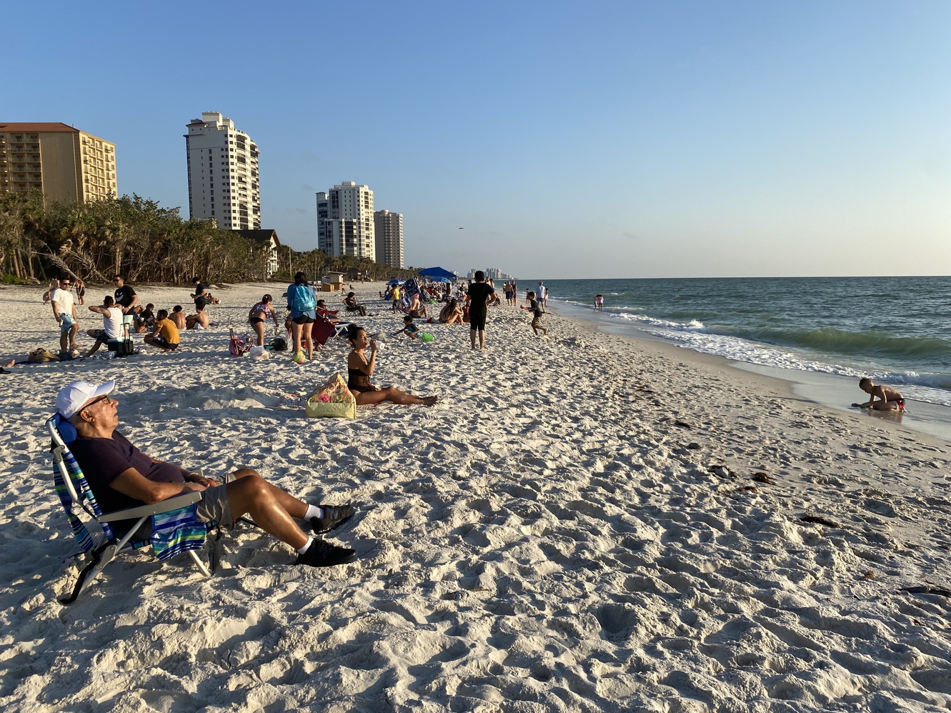 At 6:45 pm, folks
      have arrived to soak in this Gulf of Mexico sunset.